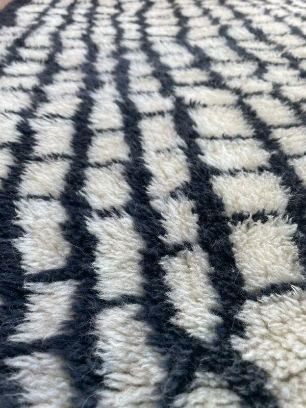 Photo d'un tapis Mrirt couloir motifs noir sur fond blanc 275X100 motif gratte ciel, le tapis Mrirt est un tapis tissé avec des doubles nœuds ce qui en fais un tapis dense et doux. Il est un des plus beau tapis contemporain du Maroc.